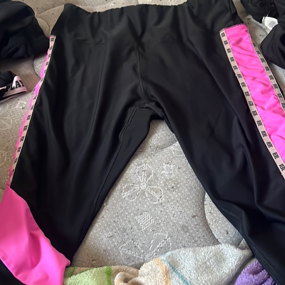 Pink and Black Bebe leggings in a size L